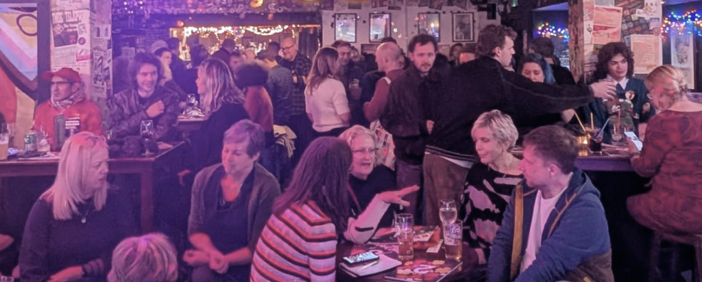 A crowded CamCreatives event with  lots of conversations happening.